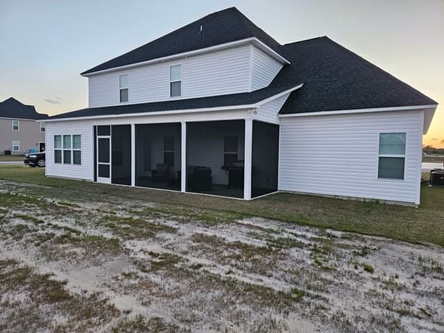 Large screen porch white home at dusk