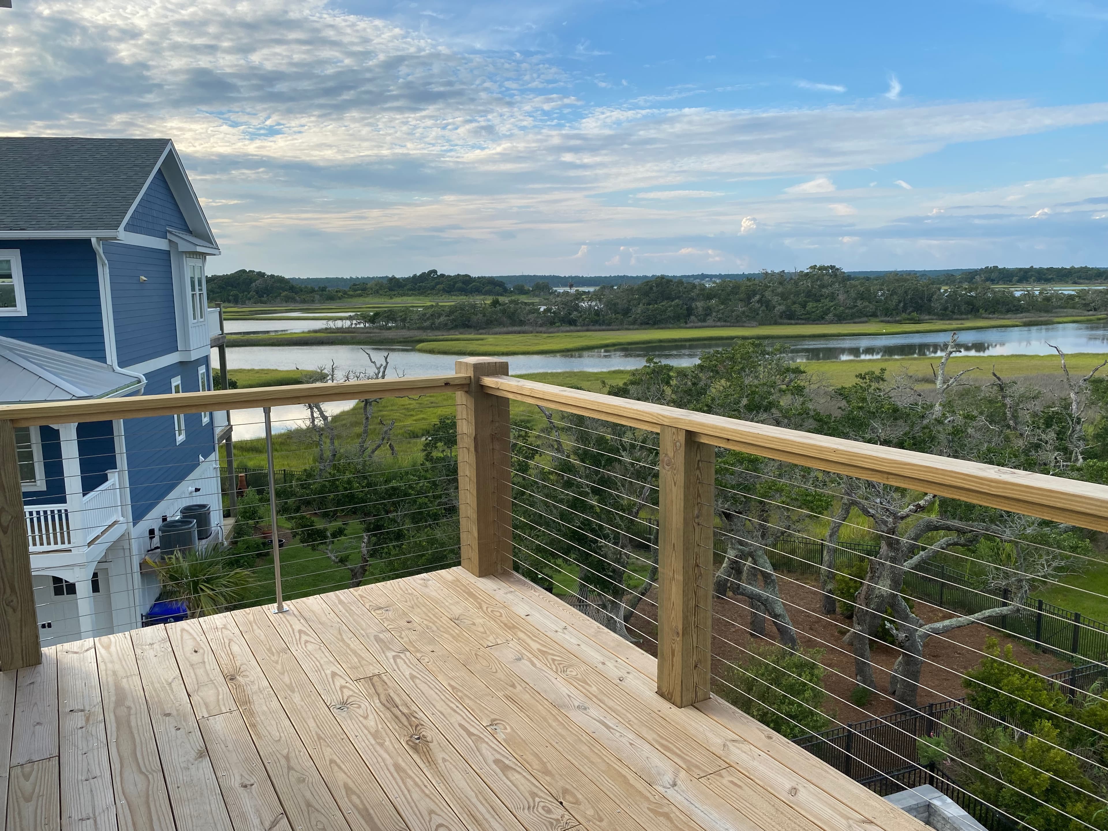 Custom deck with cable railing overlooking coastal marsh — Eastern NC