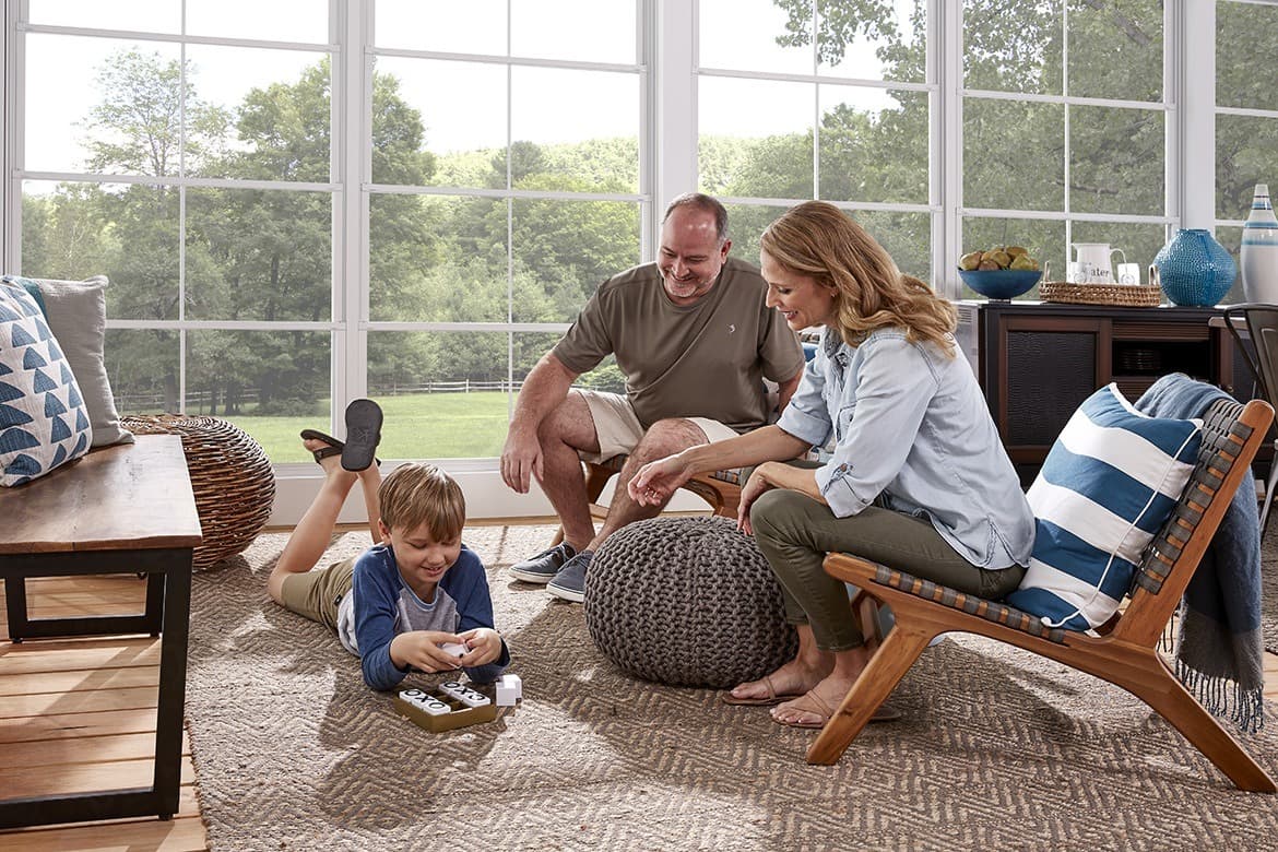Family enjoying their EZ Breeze sunroom — Eastern NC