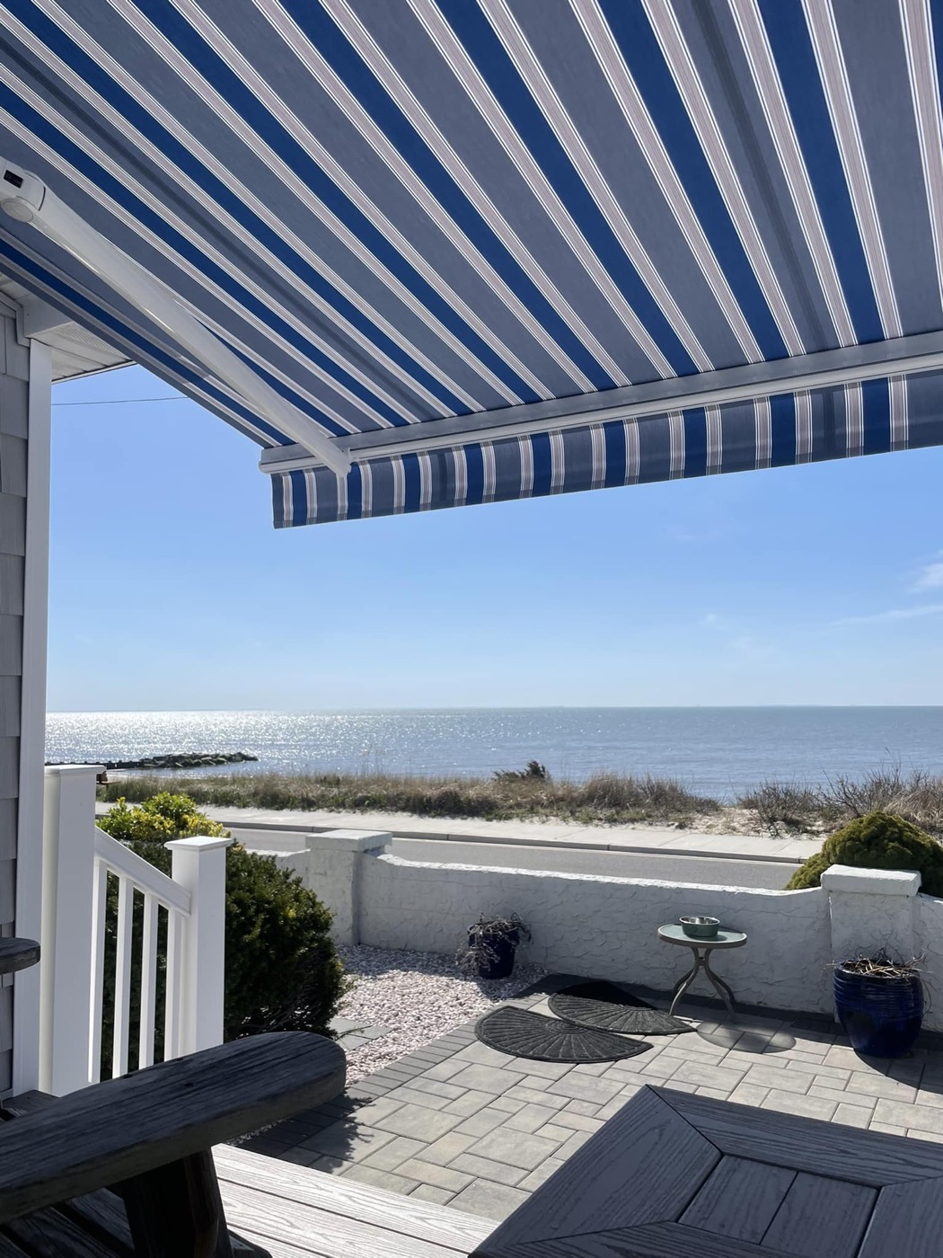 Coastal patio with retractable awning overlooking the water